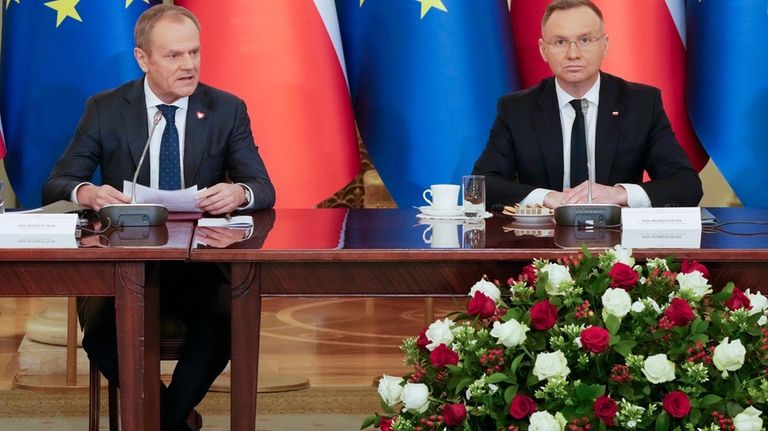 Poland's Prime Minister Donald Tusk, left, and President Andrzej Duda...