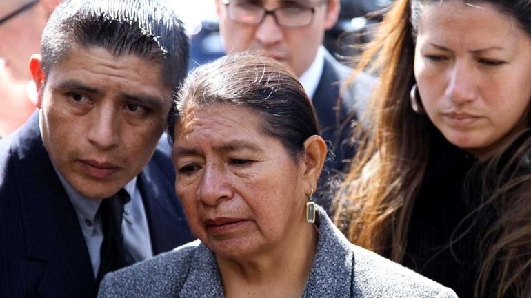 Rosario Lucero, center, stands with son Joselo Lucero, left, near...