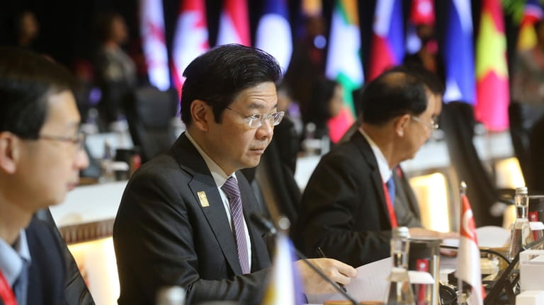Singaporean Finance Minister Lawrence Wong, center, attends the plenary session...