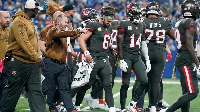 Tampa Bay Buccaneers quarterback Baker Mayfield (6) is helped off...