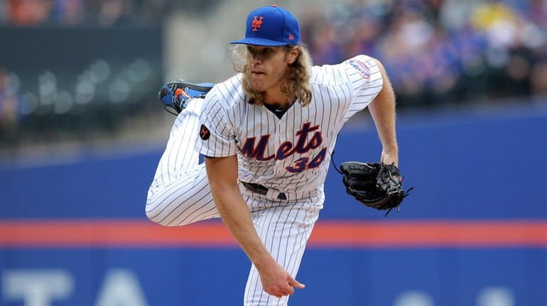Mets starting pitcher Noah Syndergaarpitches against the Rockies during the...