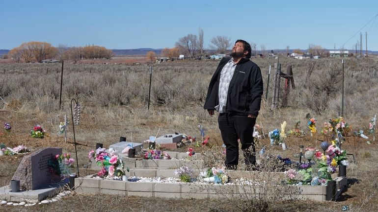 Shoshone-Paiute tribal member Michael Hanchor visits his mother’s grave, March...