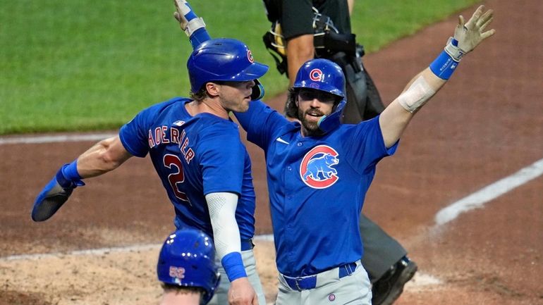 Chicago Cubs' Dansby Swanson, right, celebrates with Nico Hoerner, left,...