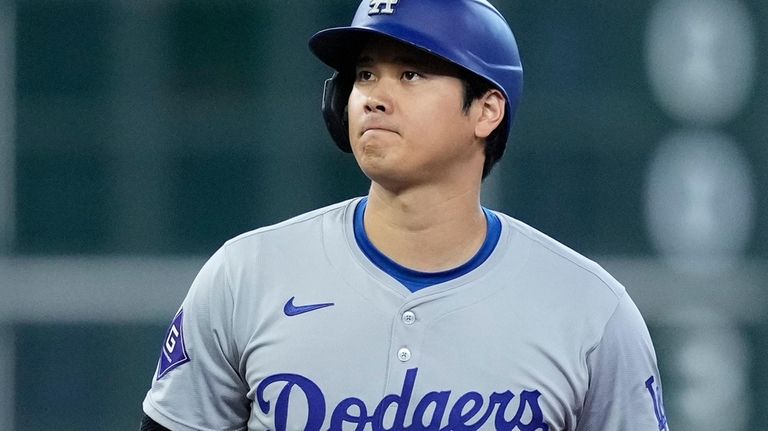 Los Angeles Dodgers designated hitter Shohei Ohtani stands after stealing...