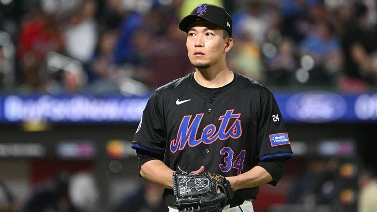 Mets starting pitcher Kodai Senga walks to the dugout after...