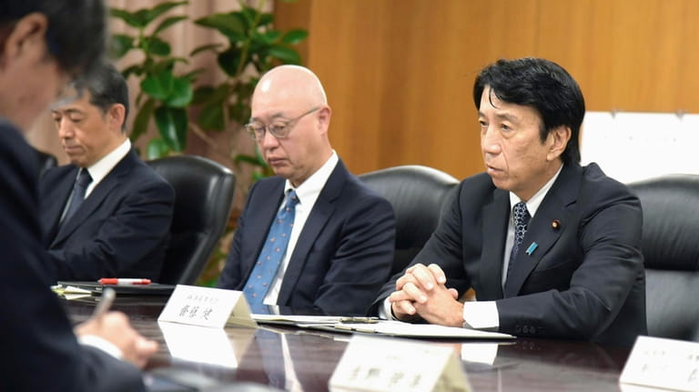 Japan's Industry Minister Ken Saito, right, holds a meeting with...