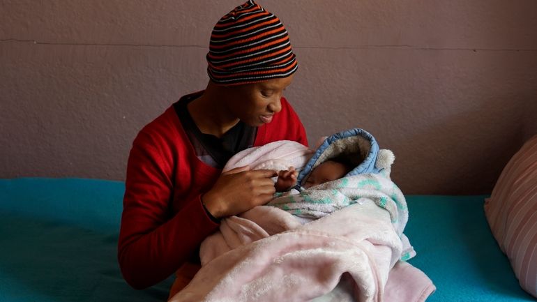 Mapule Radebe holds her baby Minehle at Nkosi's Haven, a...