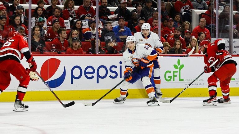 Mathew Barzal #13 of the New York Islanders skates against...