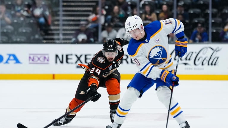 Anaheim Ducks center Bo Groulx, left, lunges for the puck...