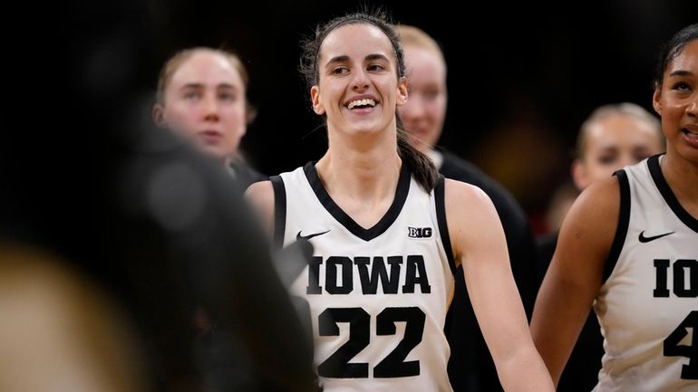 Iowa guard Caitlin Clark heads to the bench for a timeout...