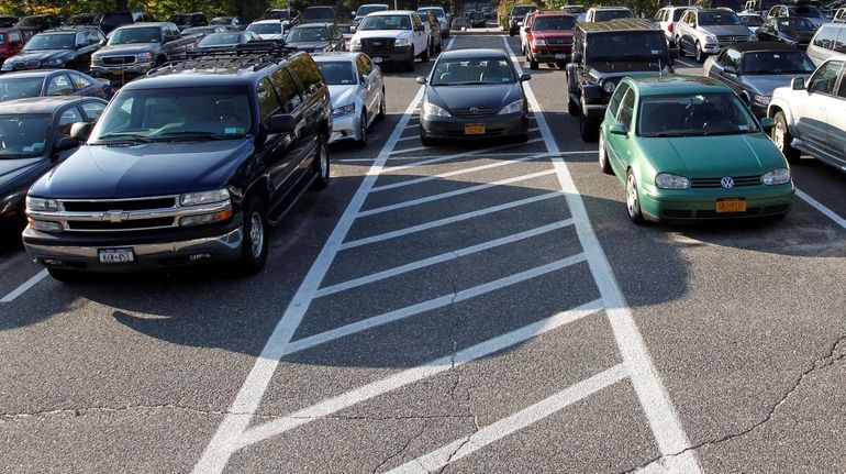 Commuters fill the parking lot at the LIRR station on...