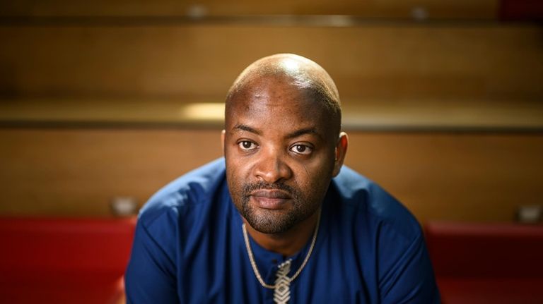 Pascal Kanyemera sits for a portrait at the National Arts...