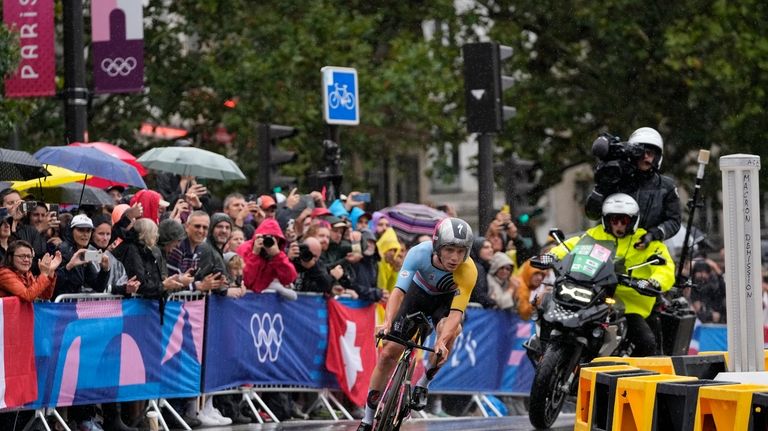 Remco Evenepoel, of Belgium, competes in the men's cycling time...