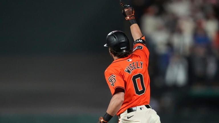 San Francisco Giants' Brett Wisely celebrates after hitting a game-winning,...