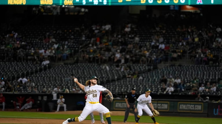 Oakland Athletics' Joey Estes (68) pitches to a Los Angeles...