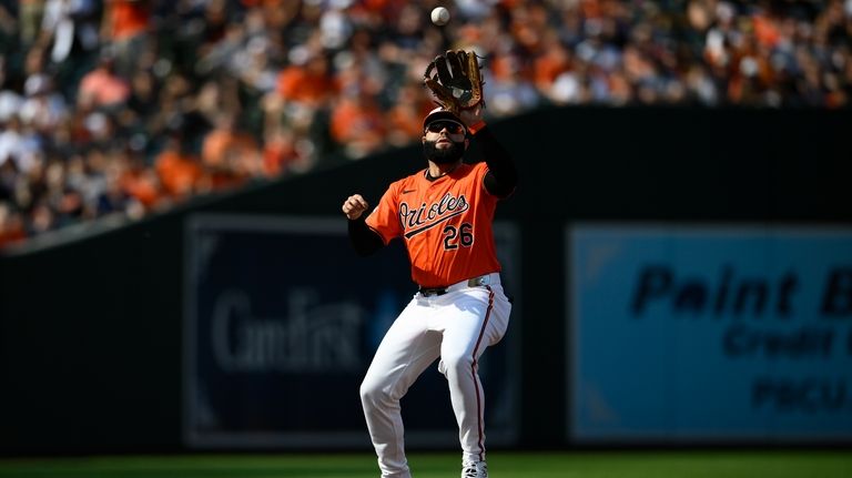 Baltimore Orioles third baseman Emmanuel Rivera fields a grounder by...