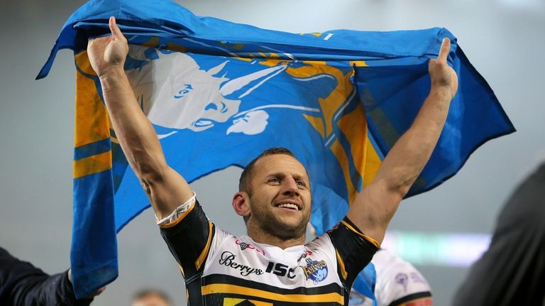 Rob Burrow holds a flag in Manchester, July 10, 2017....