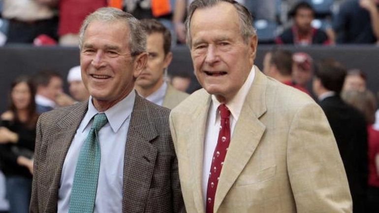 Former President George W. Bush, left, with his father, George...