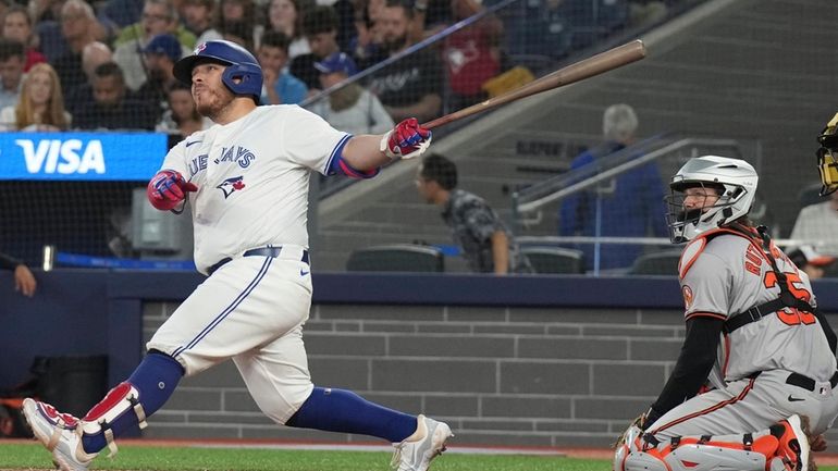 Toronto Blue Jays' Alejandro Kirk hits a three-run home run...