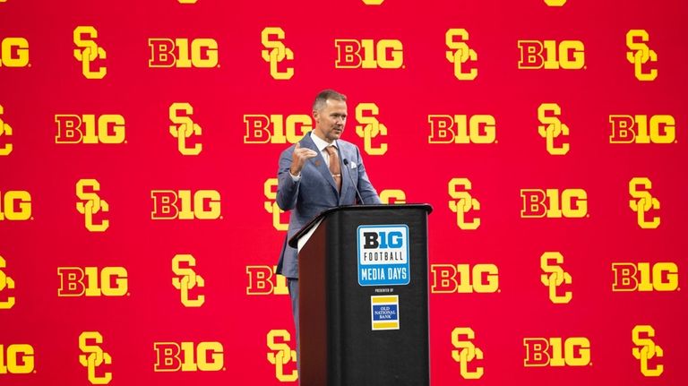 Southern California head coach Lincoln Riley talks with reporters during...