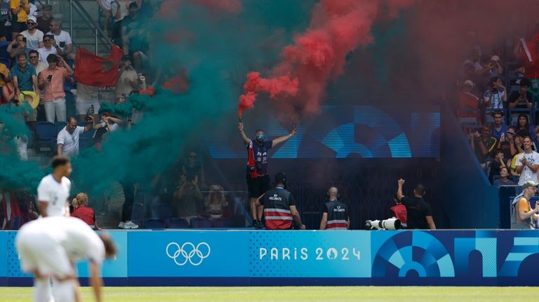 Morocco supporters celebrate after Soufiane Rahimi scored the opening goal...