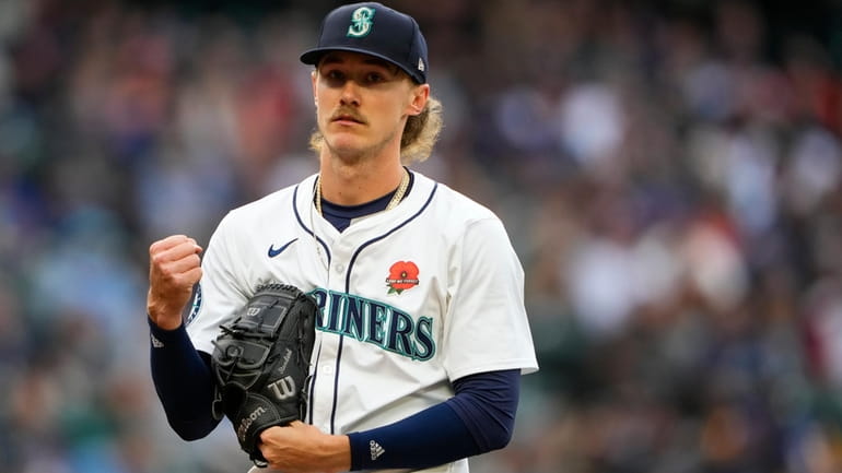 Seattle Mariners starting pitcher Bryce Miller makes a fist after...