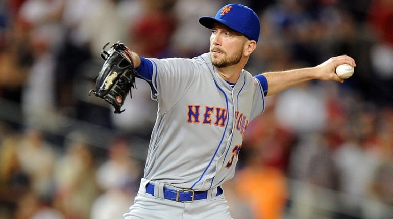 The Mets' Jerry Blevins pitches in the 10th inning against...