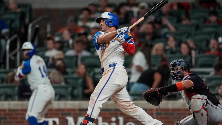 Atlanta Braves outfielder Ramón Laureano (18) hits a solo homer...