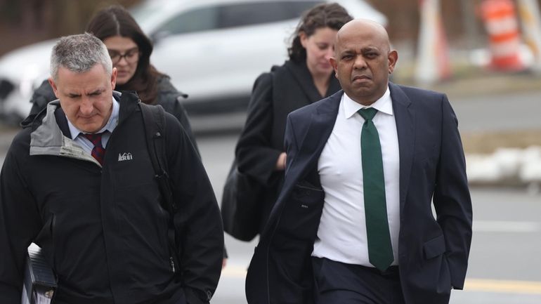 Mathew James, right, arrives at federal court in Central Islip...