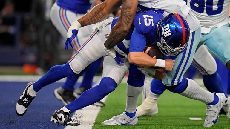 Giants quarterback Tommy DeVito is sacked by Cowboys defensive end Sam...