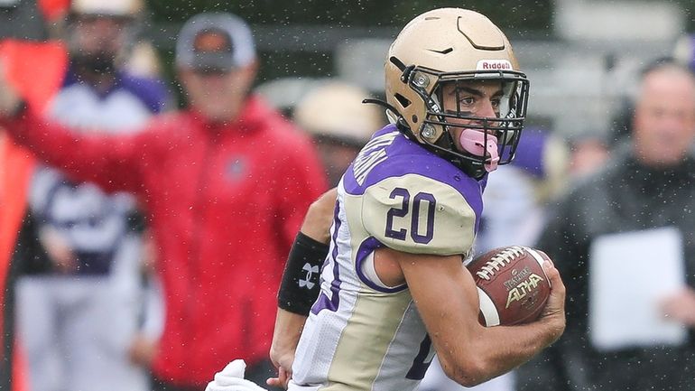 Sayville's Kyle Messina runs the ball inthe first quarter during...