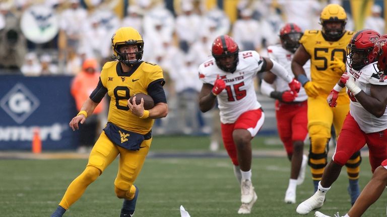 West Virginia quarterback Nicco Marchiol carries the ball on a...