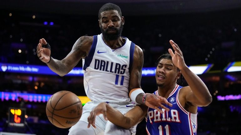 The Mavericks' Kyrie Irving, left, and the 76ers' Jaden Springern,...