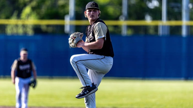 Evan Kay #23 for Commack delivers a pitch during the...