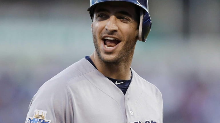 Ryan Braun of the Milwaukee Brewers reacts after hitting a...