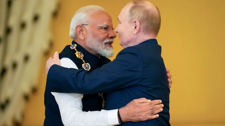 FILE- Russian President Vladimir Putin, right, awards Indian Prime Minister...