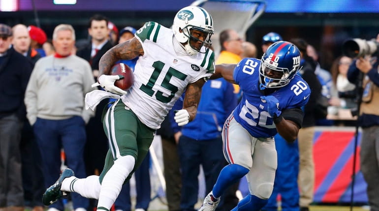 The Jets' Brandon Marshall runs after making a catch against...