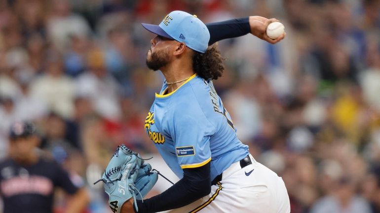 Milwaukee Brewers' starting pitcher Freddy Peralta throws to the Cleveland...