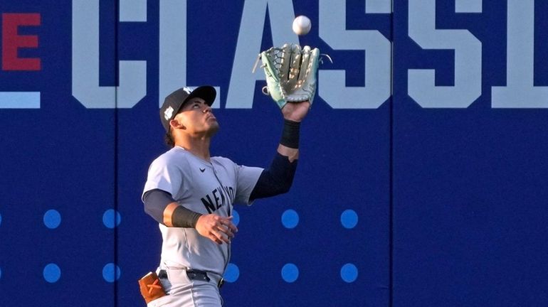 Yankees left fielder Jasson Dominguez catches a fly ball by...