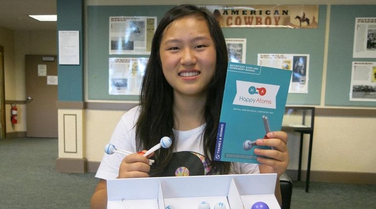 Kidsday reporter Elaine Jiao with  the STEM game Happy Atoms.