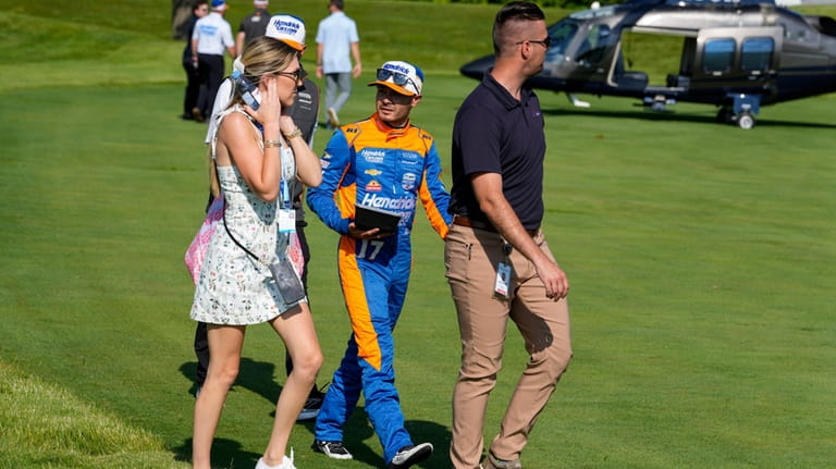 Kyle Larson, center, and his wife Katelyn Sweet board a...