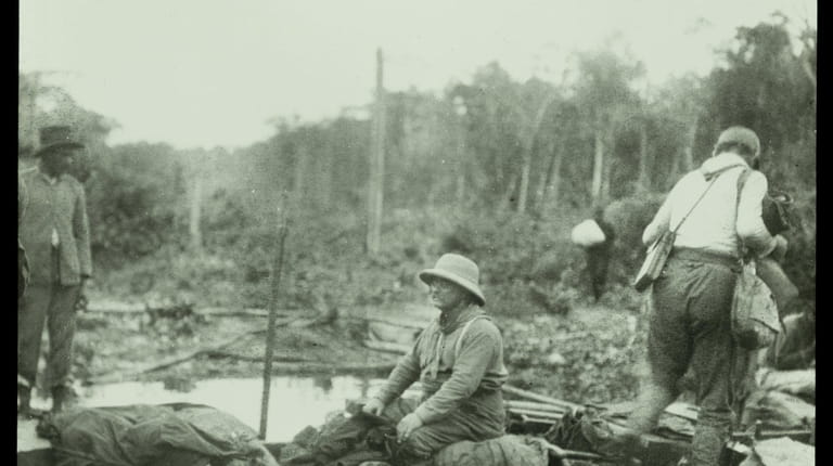 Theodore Roosevelt seated in a boat during the during the...
