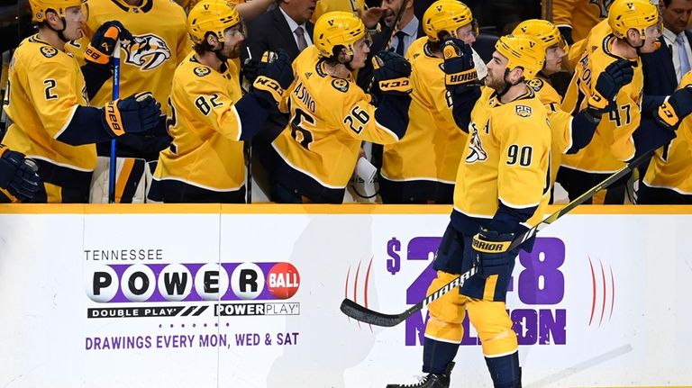 Nashville Predators center Ryan O'Reilly (90) is congratulated after scoring...