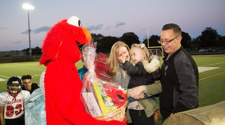 Madison Anderson with her parents Kristen and Greg as she's  greeted by...