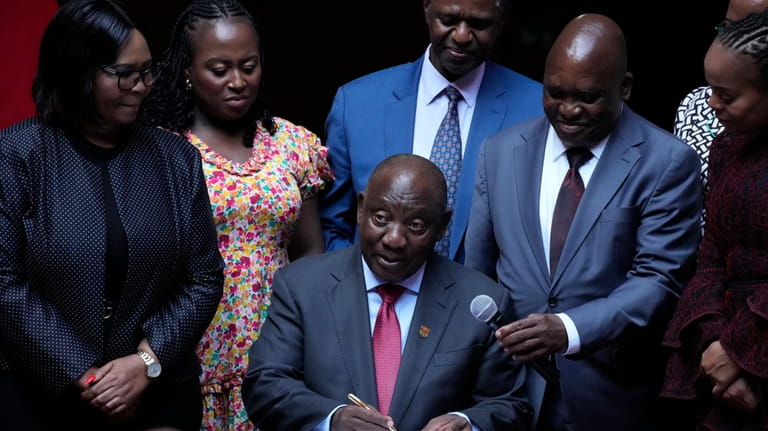 South African President Cyril Ramaphosa signs a bill for National...