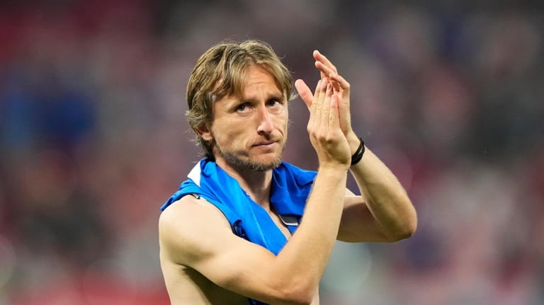 Croatia's Luka Modric waves supporters at the end of a...