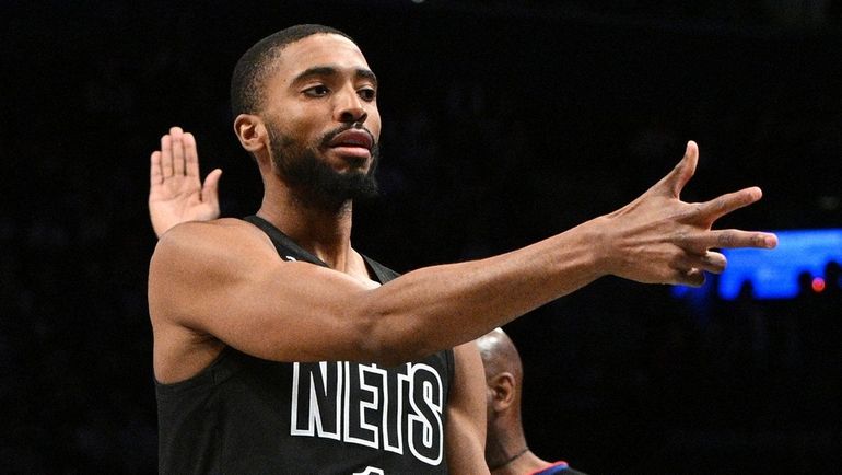 Nets forward Mikal Bridges reacts after sinking a three-point basket...