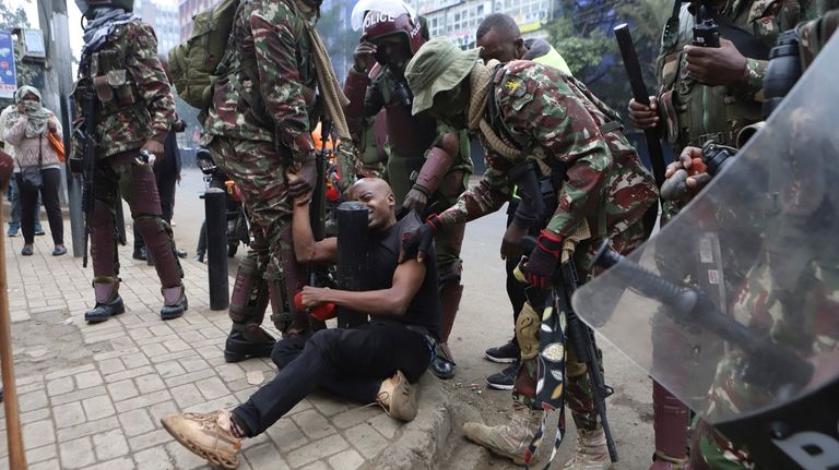 A protester is arrested in Nairobi, Kenya, Thursday Aug. 8,...