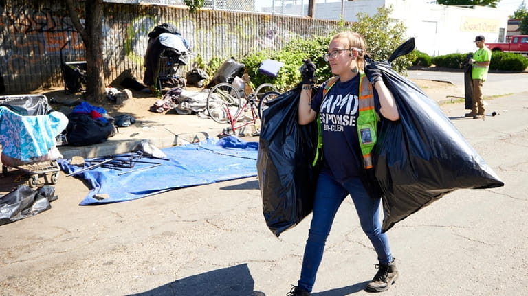 Amber Nastasia from Rapid Response Bio Cleanup cleans a homeless...