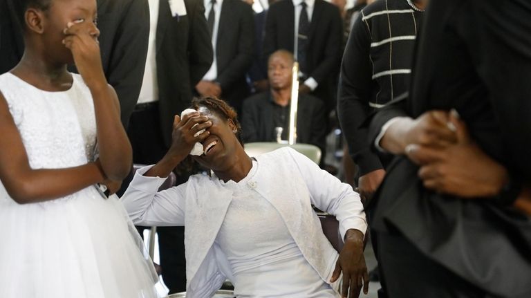 Relatives of Luciana Pierre, a police officer killed in an...